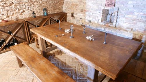 a wooden table with utensils on top of it at Hillside Apartments in Révfülöp