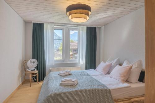 a bedroom with a bed with towels on it at Hasel in Interlaken