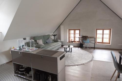 a living room with a couch and a table at Flösserhaus Steyr - Wohnen am Fluss in Steyr