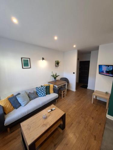 a living room with a couch and a table at Apartament Na Rynku in Bytom