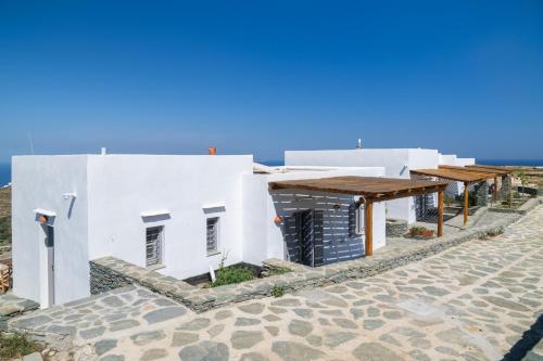 a white building on the side of a street at Taeri Sifnos in Sifnos
