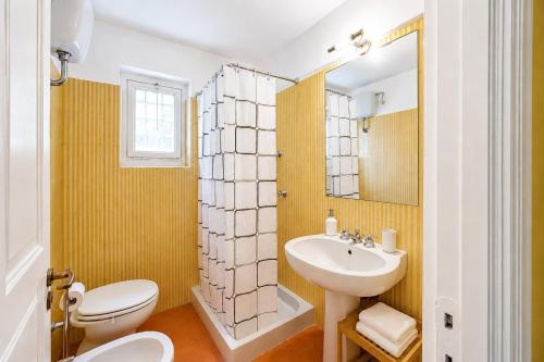 a bathroom with a white toilet and a sink at Villa Roberta Pool, wifi & Parking in Arenzano