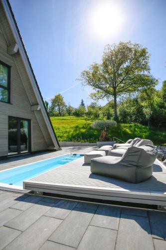 a row of pillows sitting next to a swimming pool at Chalet NATURTRAUM in Runkel