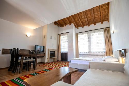 a living room with a couch and a table at Студио in Starosel