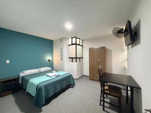 a bedroom with a bed and a desk in it at Dream Place Trujillo in Trujillo