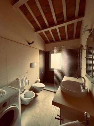 a large bathroom with two toilets and a sink at Matteotti28 in Pesaro