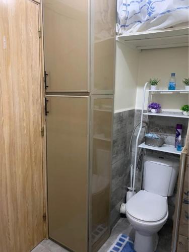 a small bathroom with a toilet and a shower at Atlas Nest in Beni Mellal