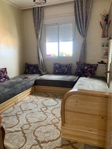 a bedroom with two beds and a window at Atlas Nest in Beni Mellal