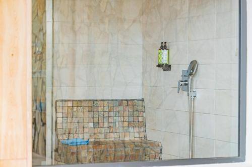 a shower with a bench in a bathroom at Playitas Hotel - Sports Resort in Las Playitas