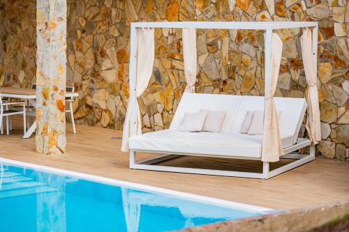 a swinging bed next to a swimming pool at Playitas Hotel - Sports Resort in Las Playitas
