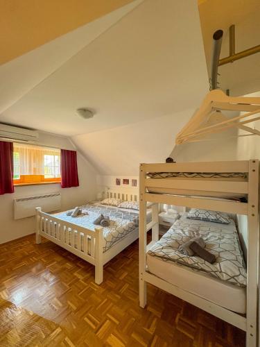 two bunk beds in a room with wooden floors at Apartma Jelenček in Moravske-Toplice