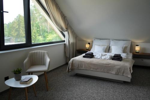 a bedroom with a bed with two stuffed animals on it at Willa na wyłączność z jacuzzi - Willa Natura Anastazewo in Szydłowiec