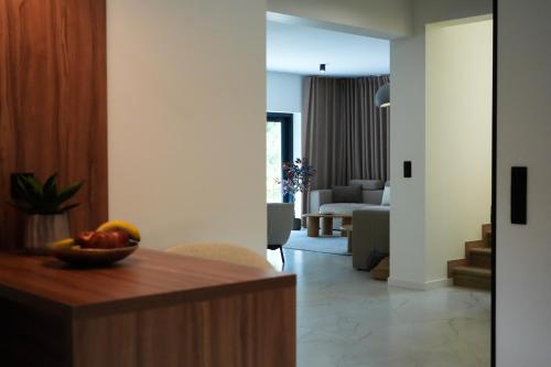 a living room with a bowl of fruit on a table at Willa na wyłączność z jacuzzi - Willa Natura Anastazewo in Szydłowiec