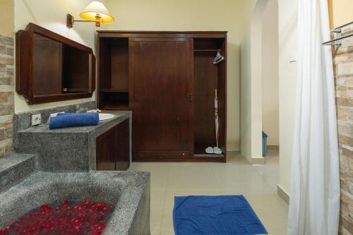 a bathroom with a sink and a bath tub at Taman Ayu Legian Hotel in Legian