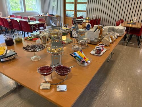 a long wooden table with wine glasses on it at Lyngmo Gjestehus in Hafslo