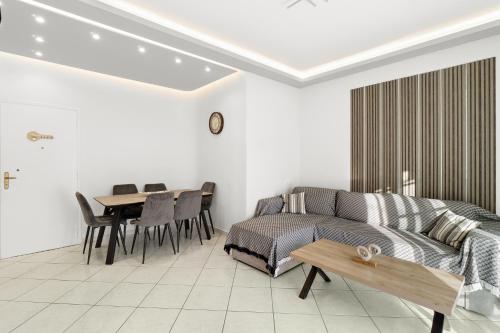 a living room with a couch and a table at Minimal Stay House in Petalidi