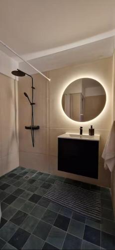 a bathroom with a sink and a mirror at Spacious Central Nicosia Flat - Quiet & SafeArea in Nicosia