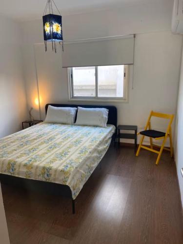 a bedroom with a bed and a table and a window at Spacious Central Nicosia Flat - Quiet & SafeArea in Nicosia