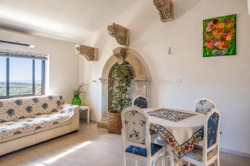 a living room with a table and chairs and a window at Casa Vacanze Panoramics in Acquedolci