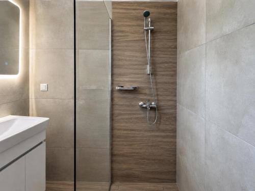 a shower with a glass door in a bathroom at Dolphin hotel in Korfos