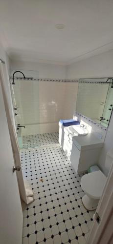 a bathroom with a shower and a toilet and a sink at Beach side studio Quindalup in Quindalup