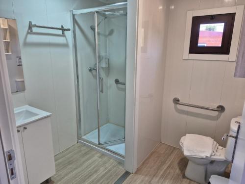 a bathroom with a shower with a glass door at São Torpes by Campigir in Sines