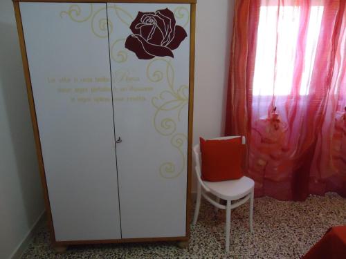 a closet with a chair next to a mirror at Villetta Dote in Casarano