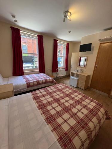 a hotel room with two beds and a window at Seven Dials Hotel in London