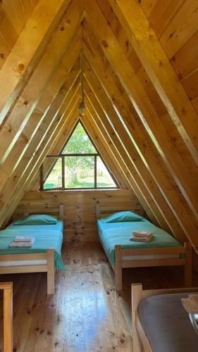 a room with two beds in a attic at Guesthouse Stanisic in Dobrilovina