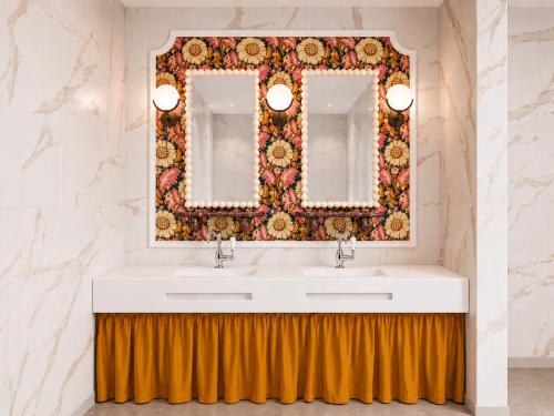 a bathroom with a sink and two mirrors at Hotel Club 29 in Barcelona
