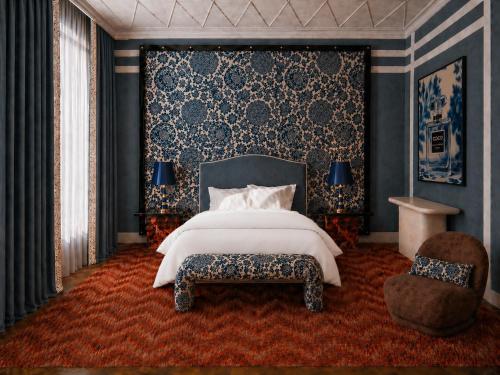 a bedroom with a large bed and a chair at Hotel Club 29 in Barcelona