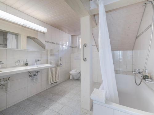 a bathroom with a shower and a sink and a toilet at Mohn in Interlaken