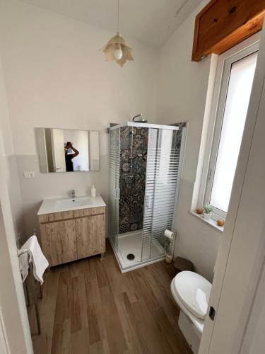 a bathroom with a shower and a toilet and a sink at Appartamenti la terrazza in Pachino