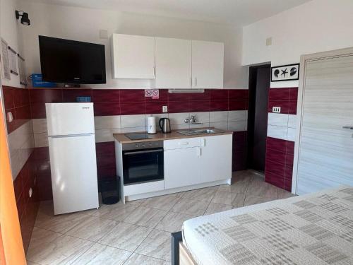 a kitchen with a white refrigerator and a sink at Apartment Verica in Krilo