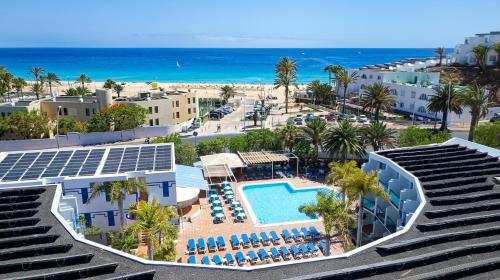 an aerial view of a resort with a swimming pool and the beach at BLUESEA Jandia Luz in Morro del Jable