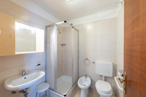 a bathroom with a sink and a toilet and a shower at VILLA NUOVA in Romeno