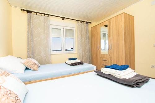 a bedroom with two beds and a window at Apartment Marin in Tkon