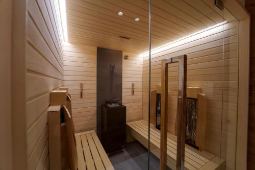 a sauna with wooden walls and a glass door at Hotel Edelweiss 3 Stelle SUPERIOR in Breuil-Cervinia