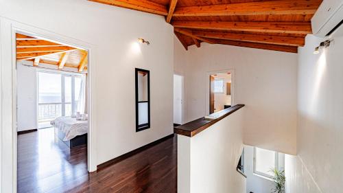a living room with white walls and wooden ceilings at Villa Antonia by Villas Guide in Blato