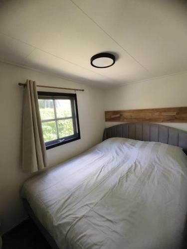 a bedroom with a white bed and a window at A View for Two in Tarchamps