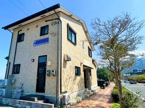 a small brick building on the side of a street at あざみ庵 屋久島 in Yakushima