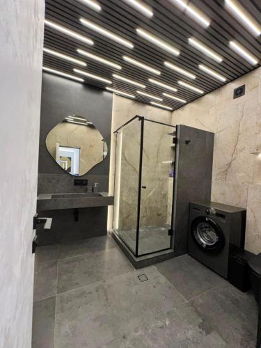 a bathroom with a shower and a mirror at Sargsyans house in Dilijan