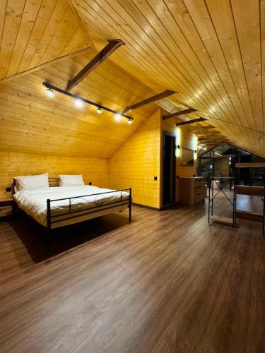 a bedroom with a bed in a wooden room at Sargsyans house in Dilijan