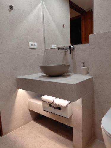 a bathroom with a bowl sink and a mirror at Ktima Kallitero Villas in Argassi