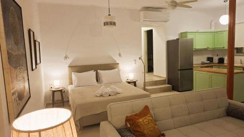a small bedroom with a bed and a kitchen at Thalassa Seaside Apartments in Sikéa