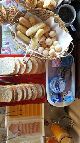 an open refrigerator filled with bread and other foods at Morada do Sol Guest House in Búzios