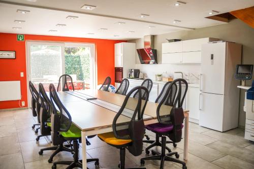 a kitchen with a long table and chairs at IDDup Atrium in Oreye