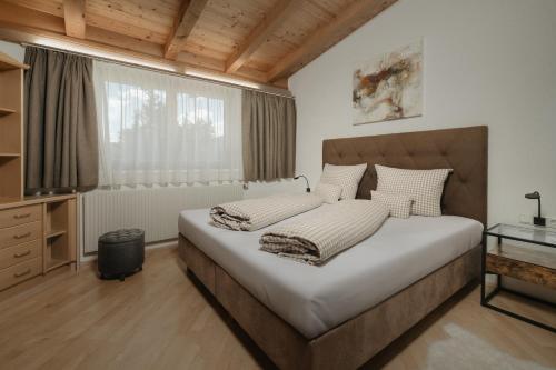 a bedroom with a large bed and a window at Lehner Schlössl in Leutasch