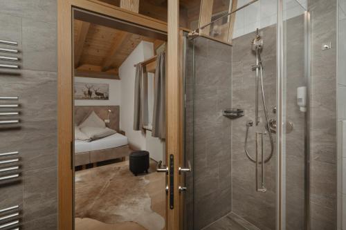 a bathroom with a shower and a glass door at Lehner Schlössl in Leutasch