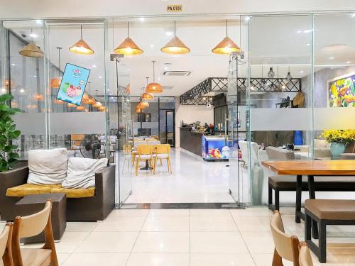 a restaurant with tables and chairs and a dining room at Bis Hotel Hồ Chí Minh in Chợ Phước Hải